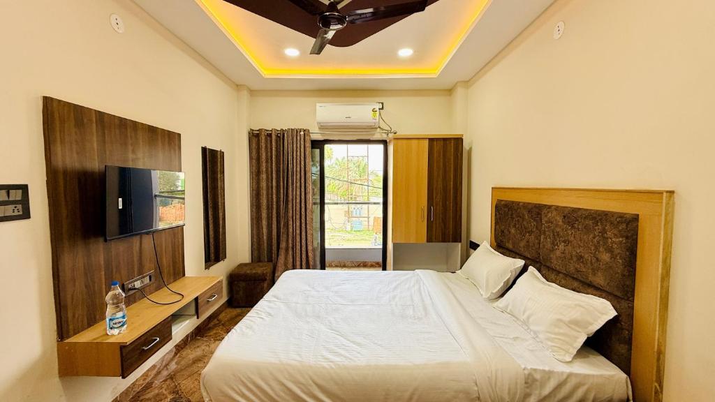 a hotel room with a bed and a television at Hotel Viraj in Indore