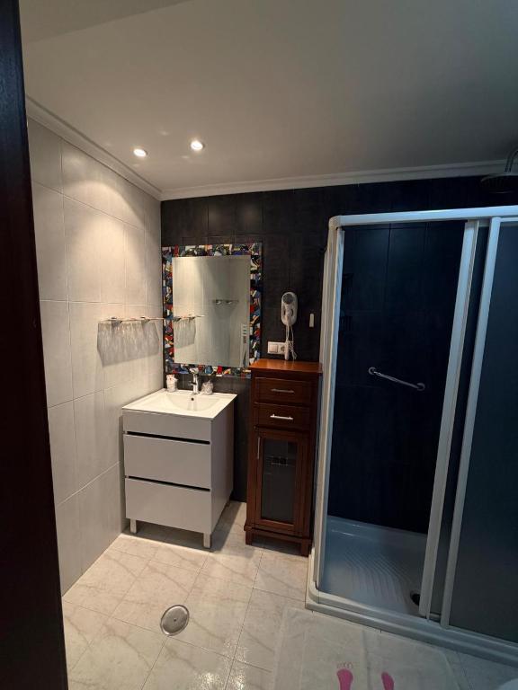 a bathroom with a sink and a shower at Hostal Inés in Boñar