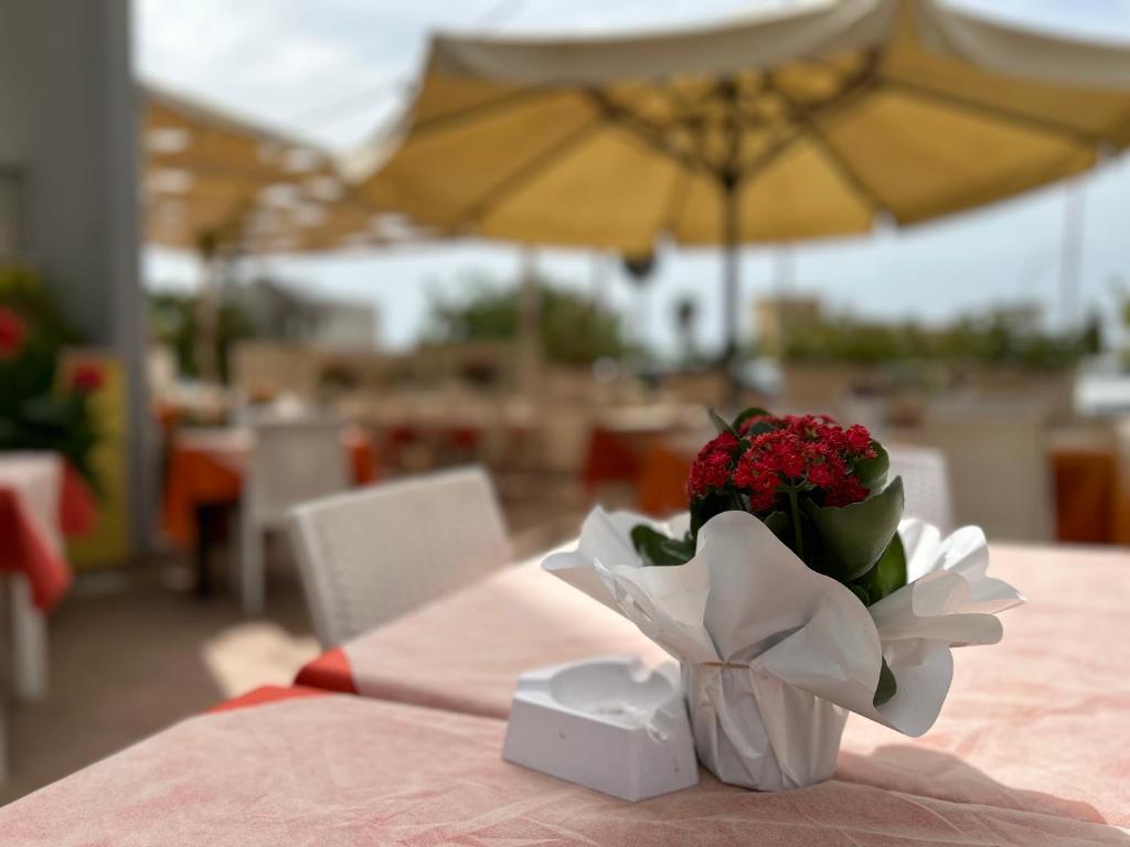 a vase of flowers sitting on a table at Hotel Costa Doro - Salve in Salve