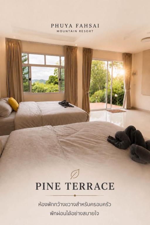 two beds in a room with a large window at Phuyafahsai The Resort Khao Kho in Khao Kho