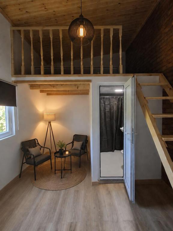 a room with two chairs and a bunk bed at Jonson in Poti