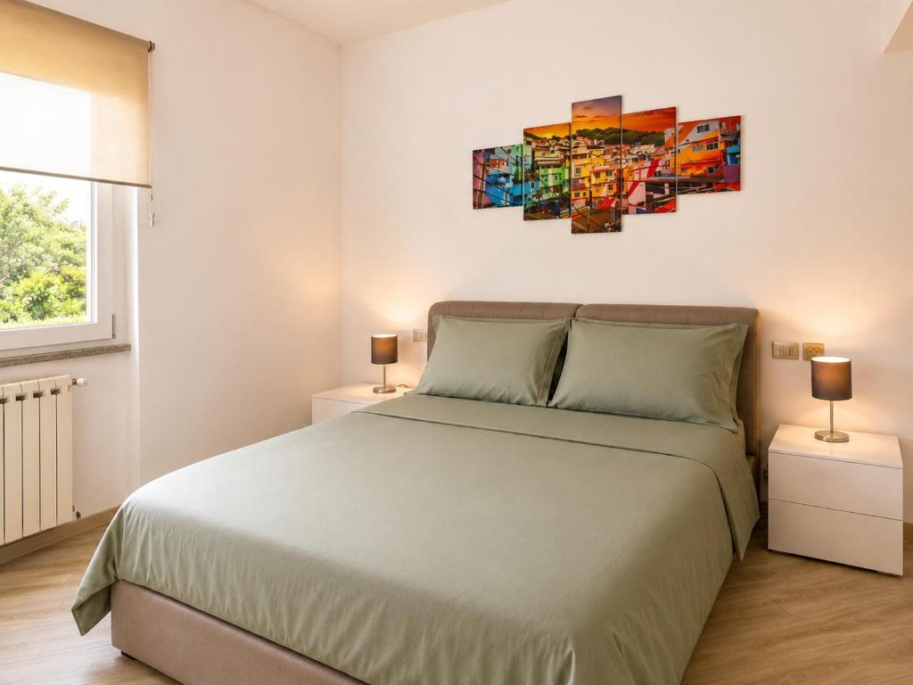 a bedroom with a large bed and two lamps at Rocca Lake House in Angera