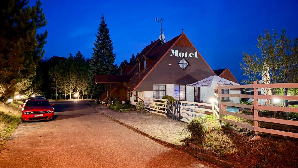 a church with a car parked in front of it at Motel Dareon in Náchod