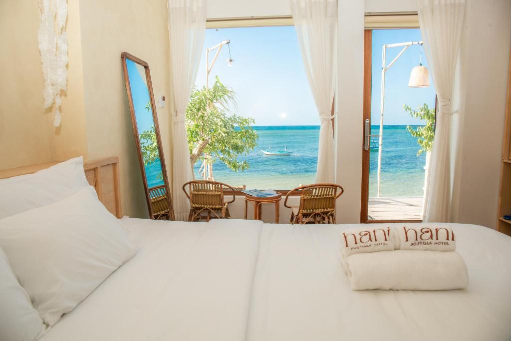 a bedroom with a bed with a view of the ocean at Hani Boutique Hotel Phú Quý in Cù Lao Thu