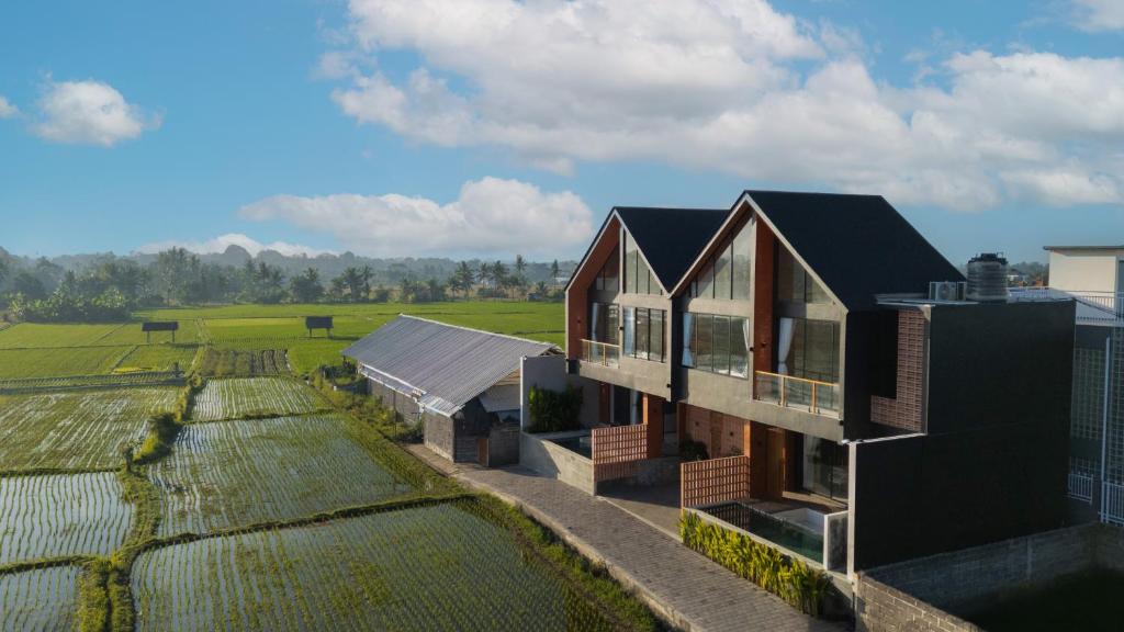 an aerial view of a house next to a field at Duality Villas in Ubud