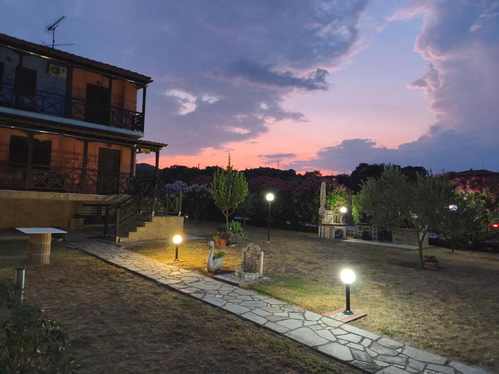 a house with lights in the yard at night at Villa near Ierissos in Ierissos