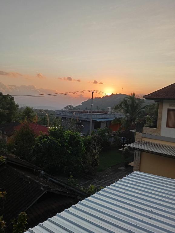 a view of the sunset from the roof of a house at Amartya Puri Green Cottages in Munduk