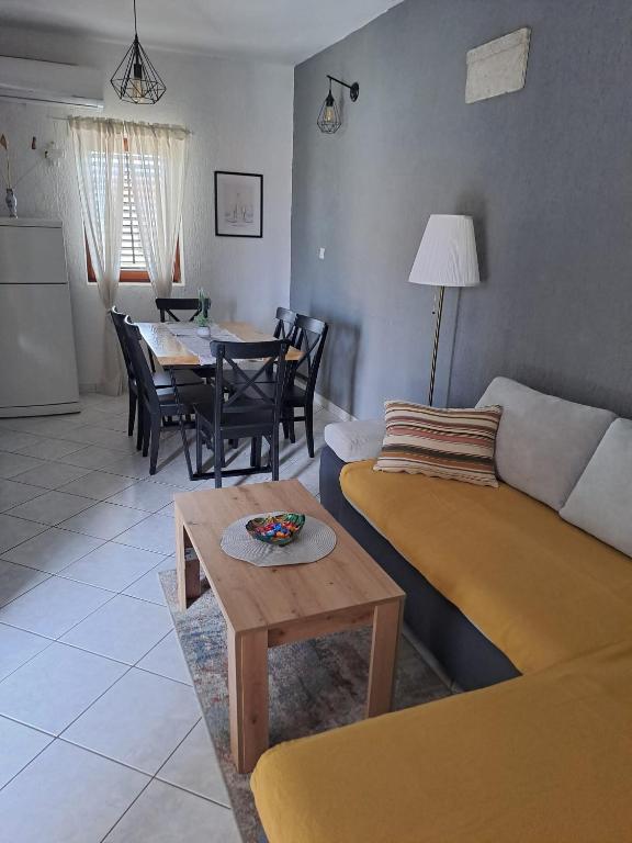 a living room with a couch and a table at Lucija in Pridraga