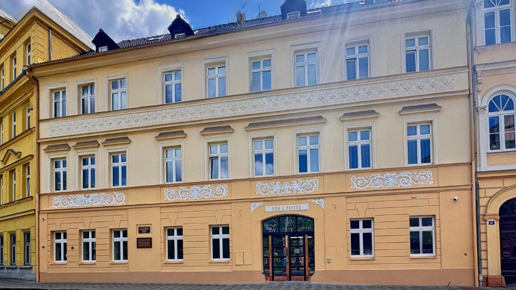 a large yellow building with a lot of windows at Hotel PAYER in Teplice