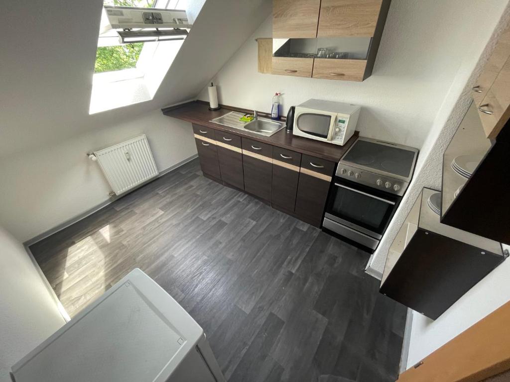 an overhead view of a kitchen with a stove and microwave at Unterkunft in Stadtnähe in Gütersloh