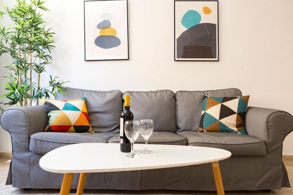 a living room with a couch and a white coffee table at Beach Palo Malaga in Málaga