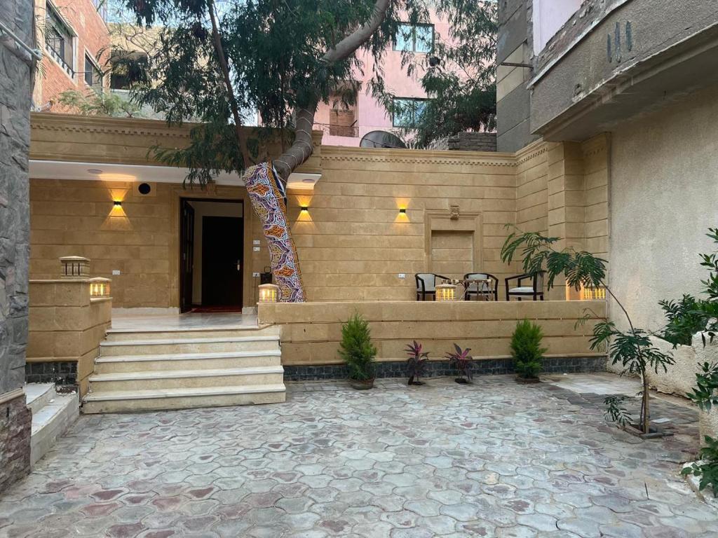 a building with stairs and tables and chairs at Phoenix Pyramids Inn in Banī Ghālib