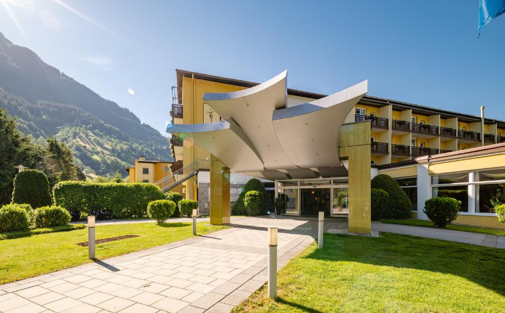a building with a sculpture in front of it at Hotel PALACE in Bad Hofgastein