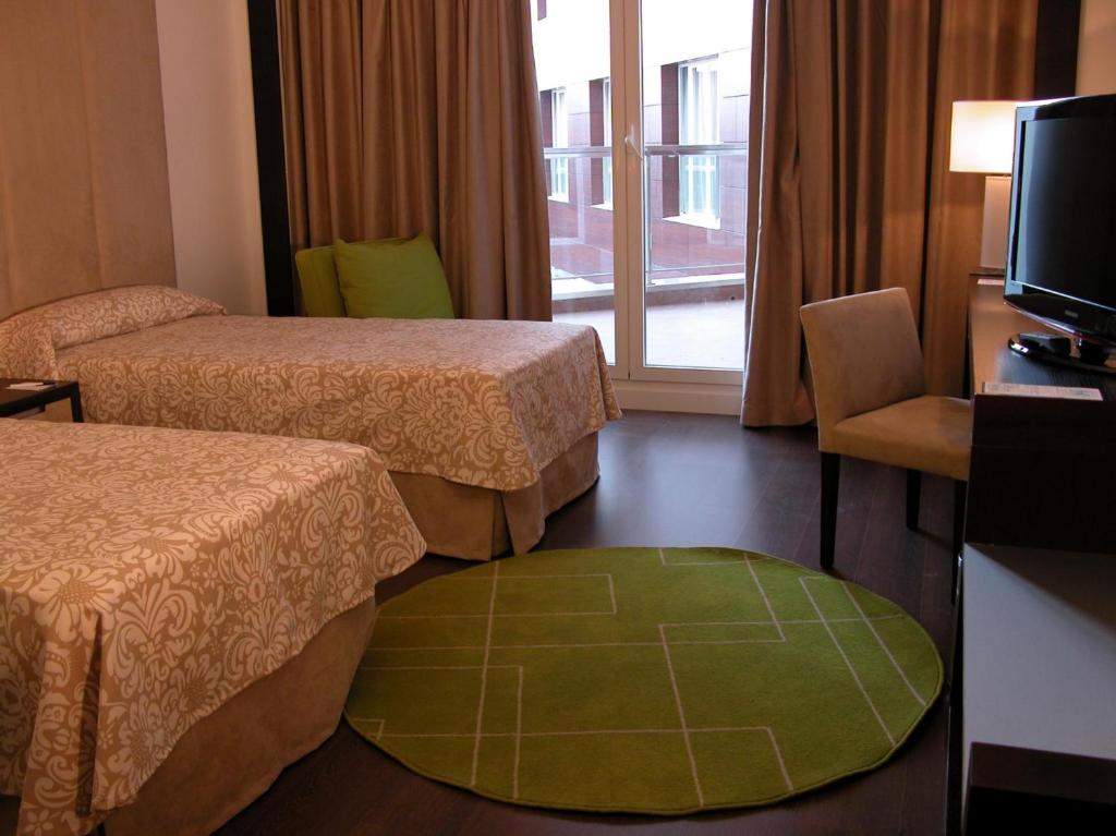 Postel nebo postele na pokoji v ubytování Hotel Palacio Albacete & SPA