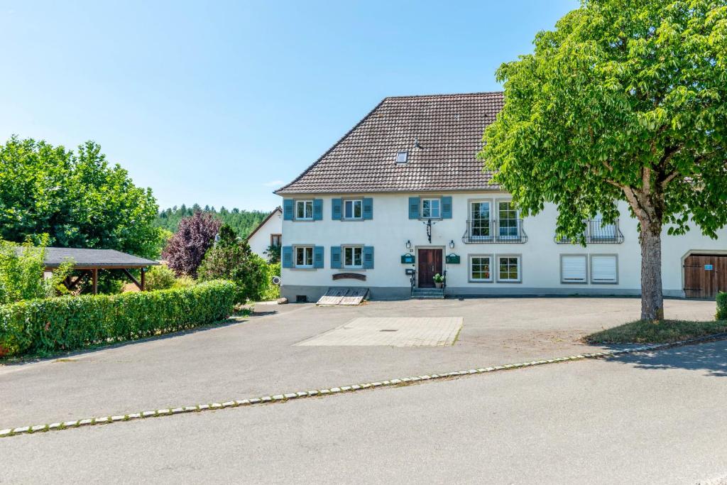 a large white house with a tree in front of it at Gästehaus Schwert in Salem