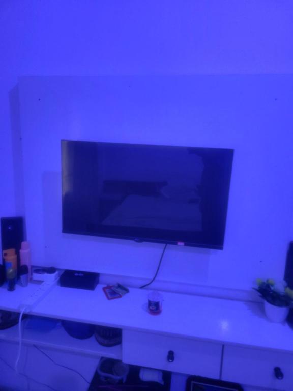 a large flat screen tv on a white wall at Mohe's place in Ilorin