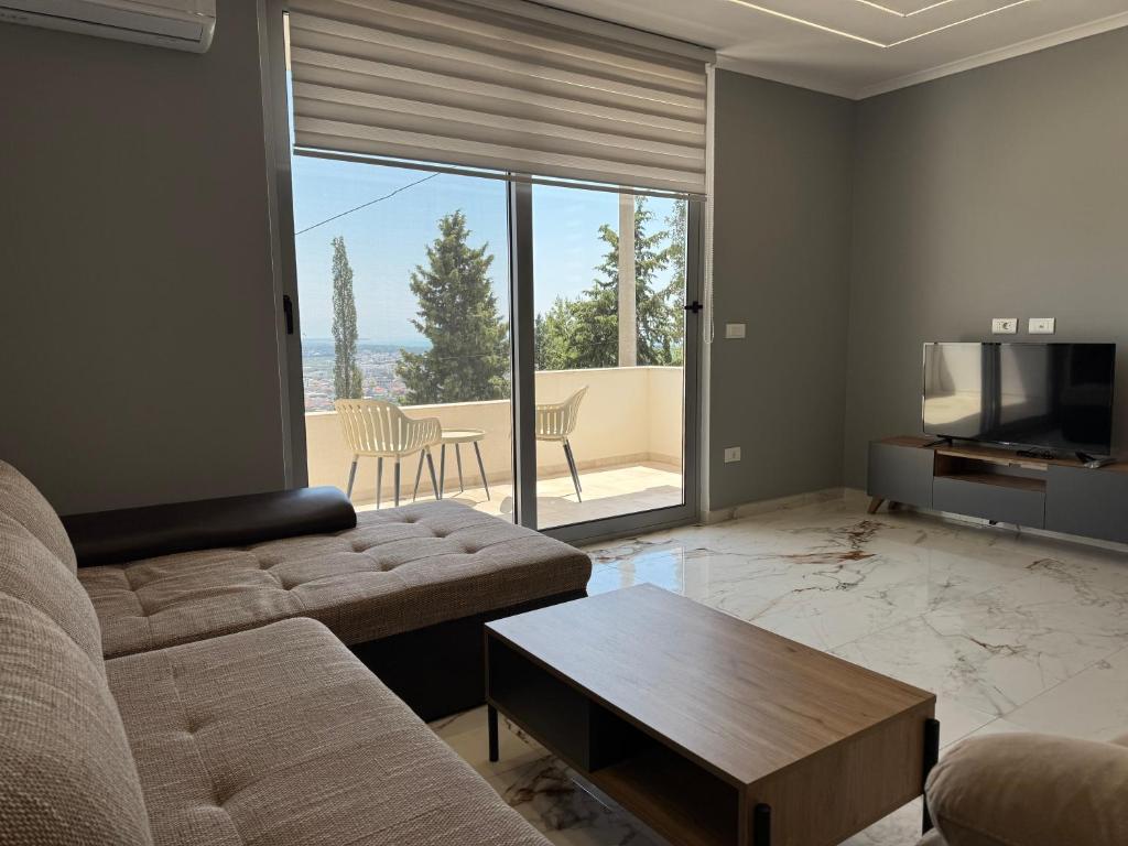 a living room with a couch and a table and a television at Paradise Luxury in Ulcinj