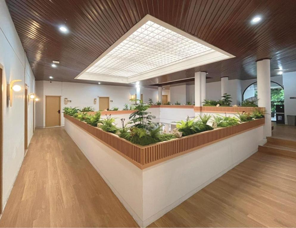 a lobby with plants in the middle of a building at Tamashii Boutique Hotel in Bandung