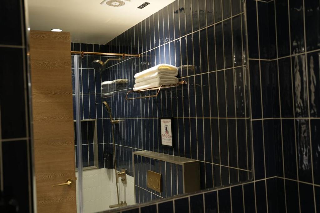 a bathroom with a mirror and a towel at Vatsalya by Vrinda in Nāthdwāra