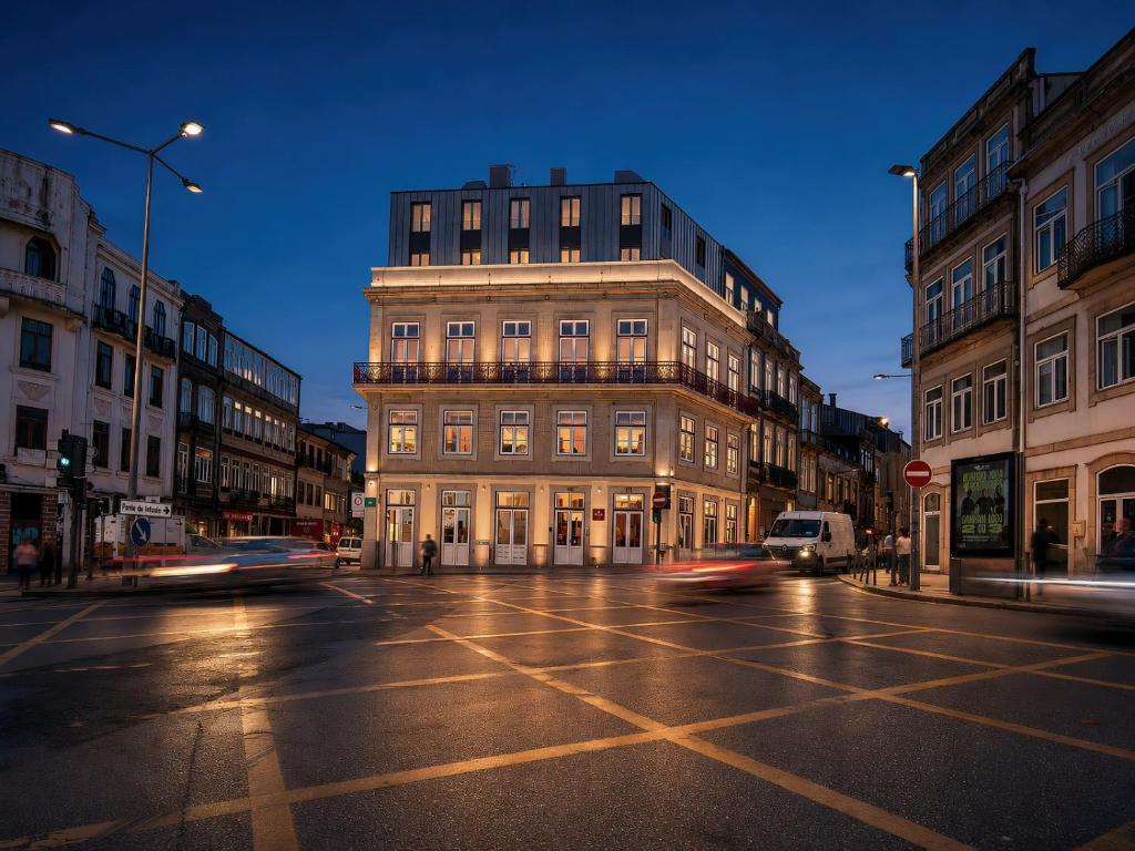 a building on a city street at night with cars at Padrão 319 - Touristic Apartments in Porto