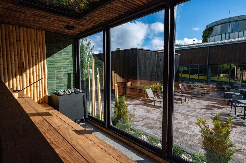 a house with large glass windows and a patio at Ikaalinen SPA & Resort in Ikaalinen