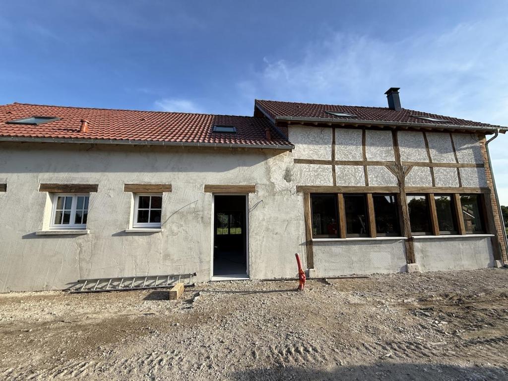 a house is being built with a lot of windows at La Grange aux Etangs - Le Gîte in Sennely