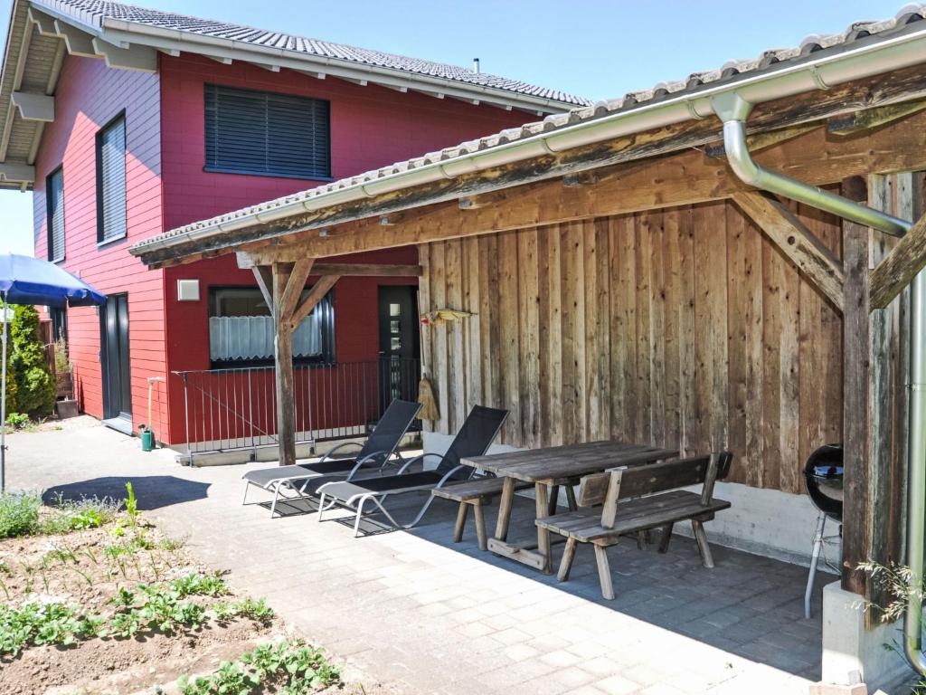 a patio with a table and chairs in front of a house at Apartment Neuheim by Interhome in Neuheim