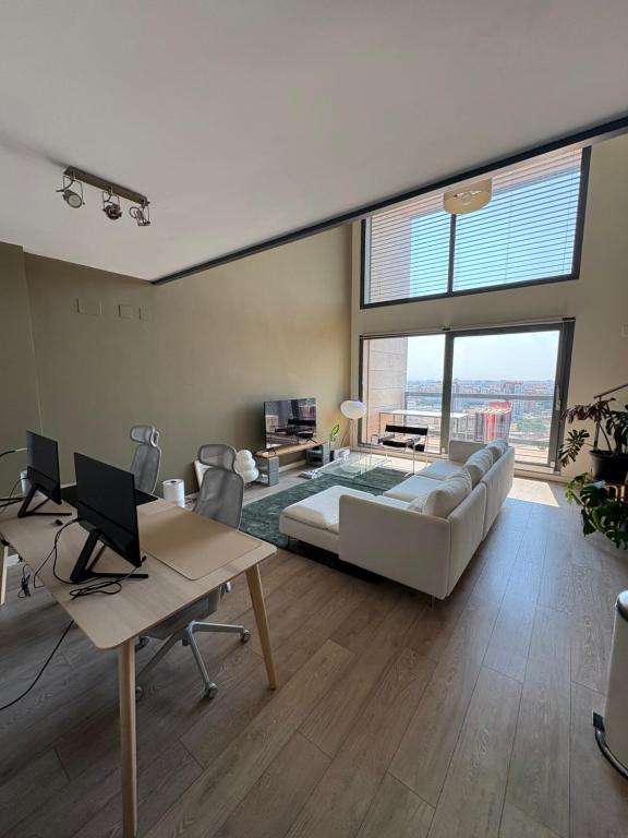 a bedroom with a large bed and a large window at Loft en Valencia in Burjassot