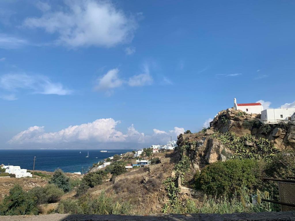 a view of a mountain with the ocean in the background at Lilly's seaview Apartment in Mikonos