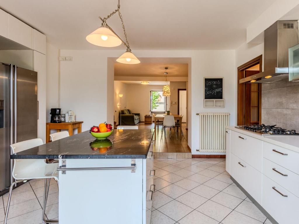 a kitchen with a counter with a bowl of fruit on it at Apartment Legnone by Interhome in Sorico