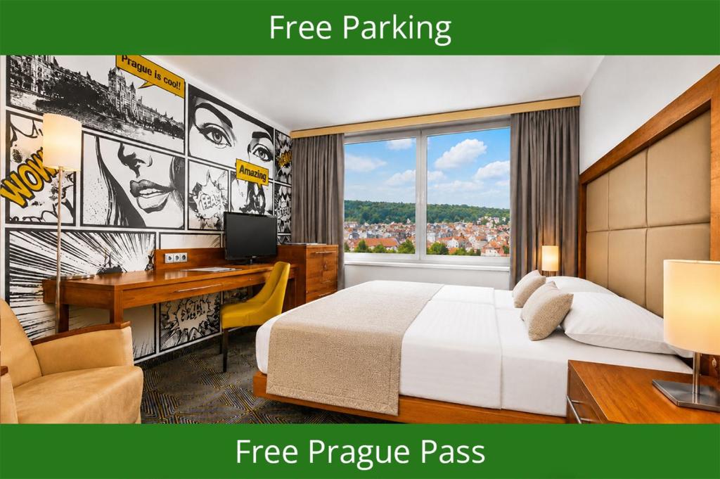 a bedroom with a bed and a desk with a computer at Hotel Uno Prague in Prague
