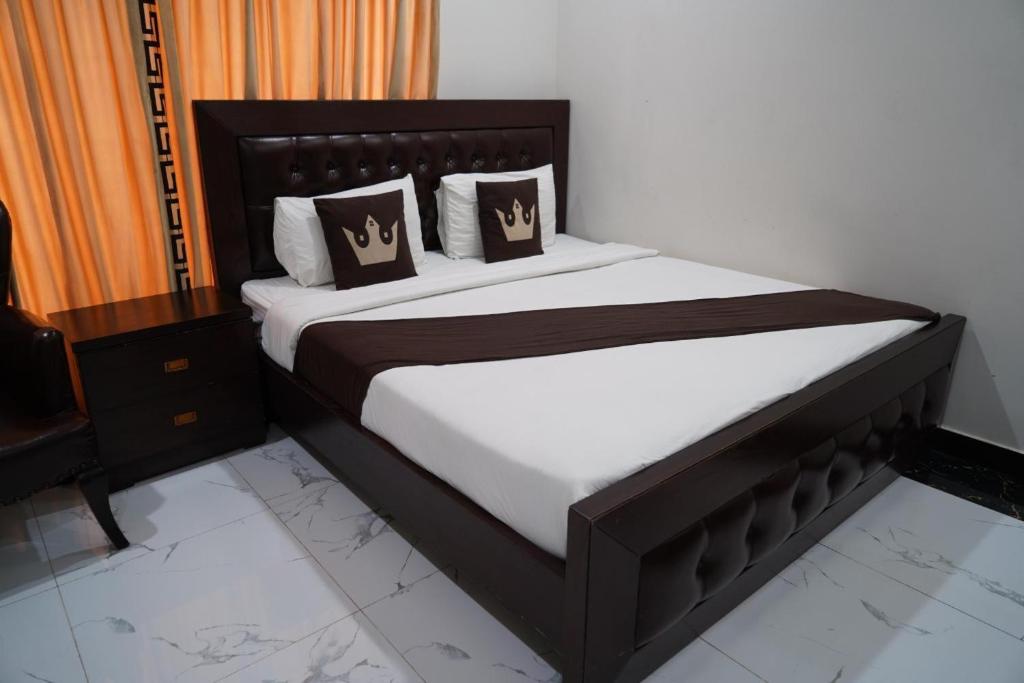 a bedroom with a large bed with brown pillows at Hotel City Top In Murree in Murree