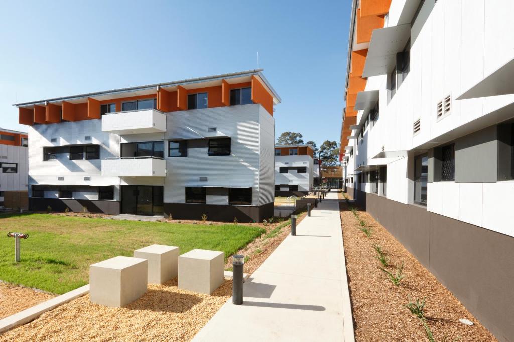 an empty sidewalk in front of an apartment building at Western Sydney University Village - Parramatta in Sydney