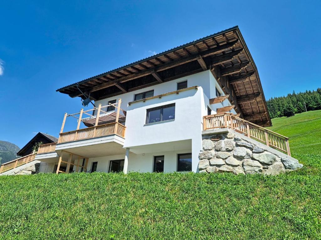 a house on top of a grassy hill at Apartment Eben by Interhome in Hippach