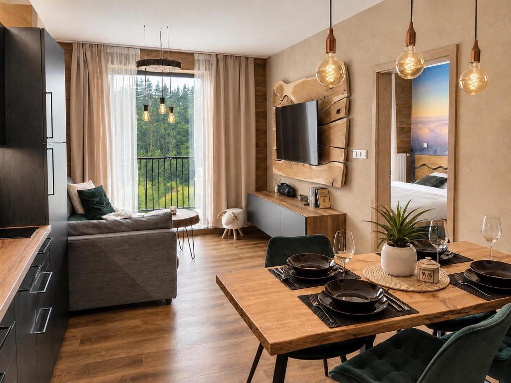 a kitchen and living room with a table and a dining room at Apartmán Dubový důl in Černý Dŭl