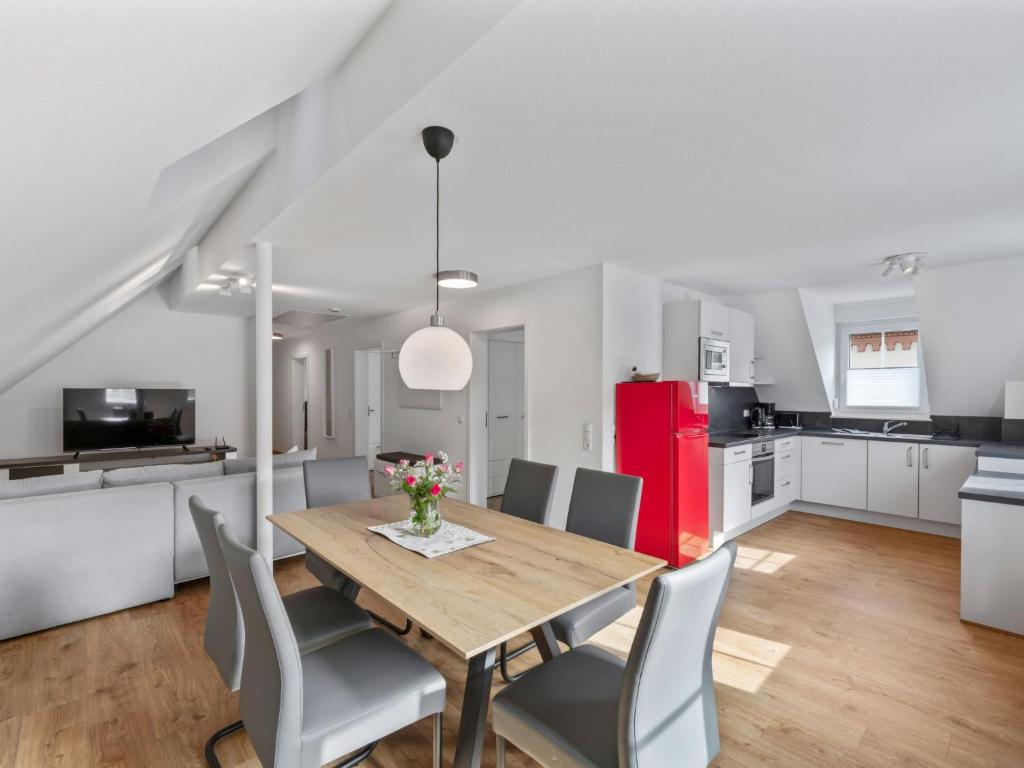 a kitchen and dining room with a wooden table and chairs at Apartment Laura - S7 by Interhome in Endingen