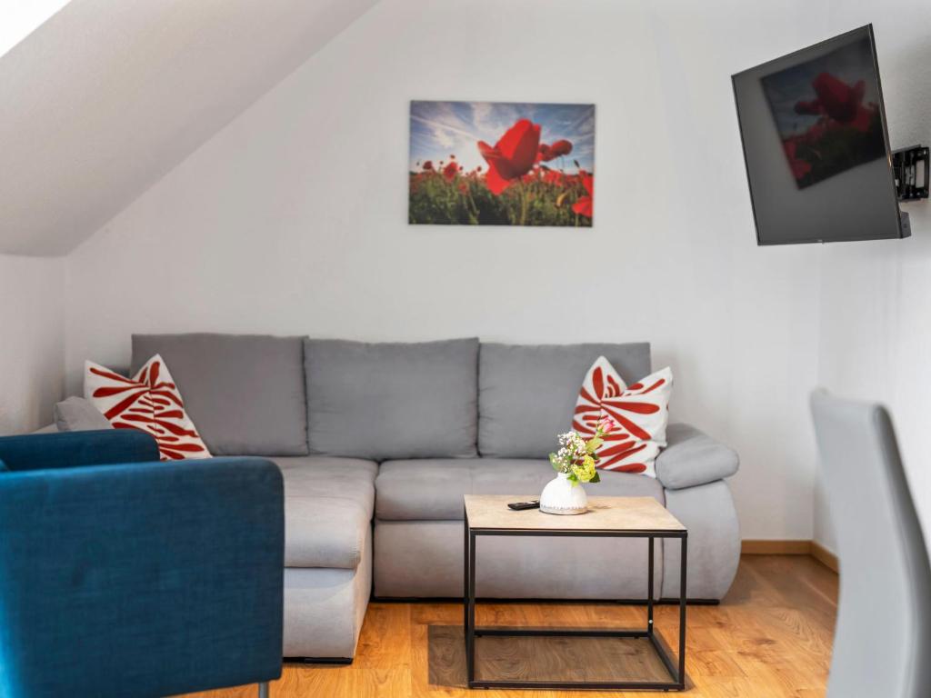 a living room with a couch and a table at Apartment Nina - 9 by Interhome in Endingen