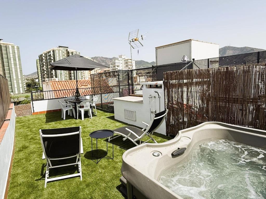 a hot tub on the roof of a building at Luxury beach penthouse with Jacuzzi in Fuengirola