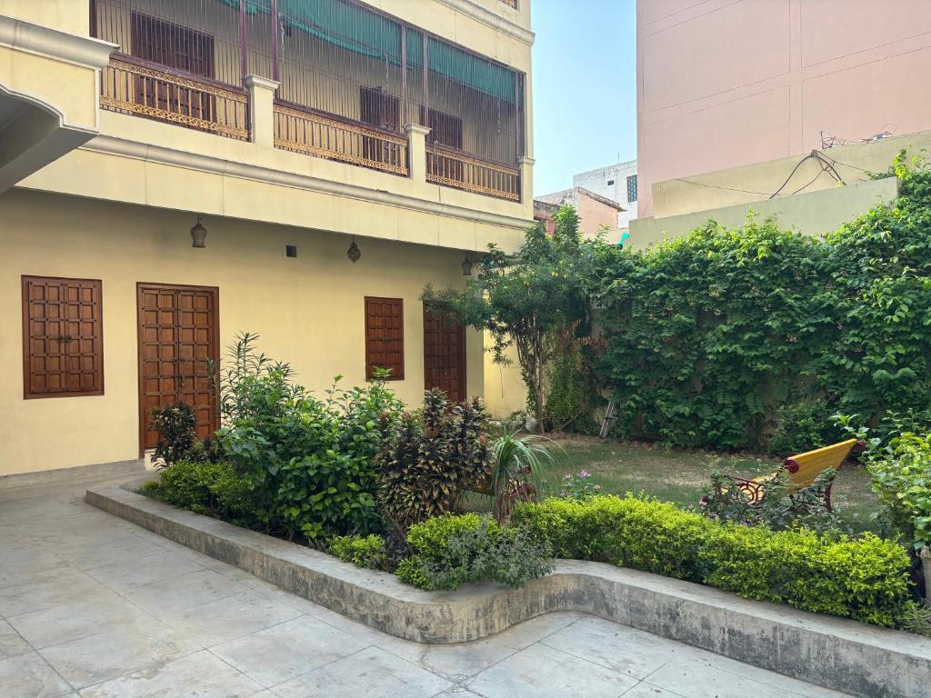 a garden in front of a building with a balcony at Homestay in Varanasi