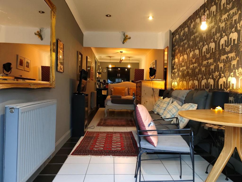 a living room with a couch and a table at Daiches Braes Brunstane Portobello in Edinburgh