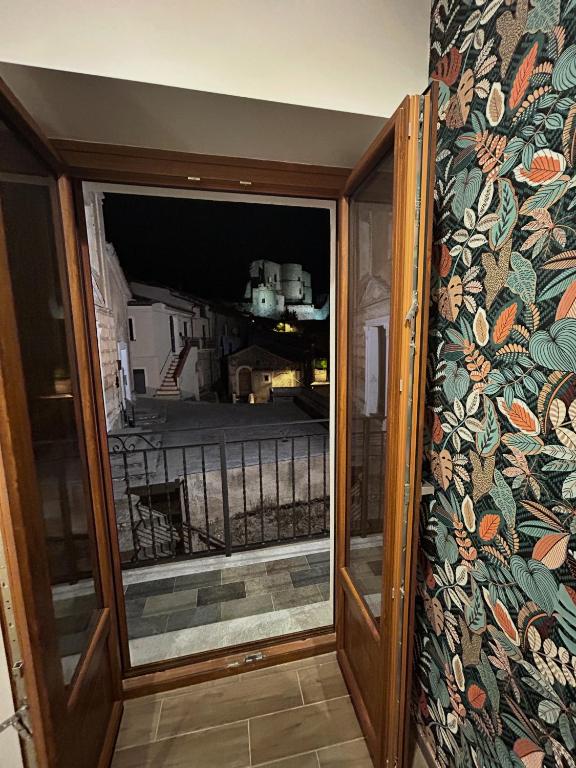 a sliding glass door with a view of a balcony at B&B La Casa Nel Borgo in Morano Calabro