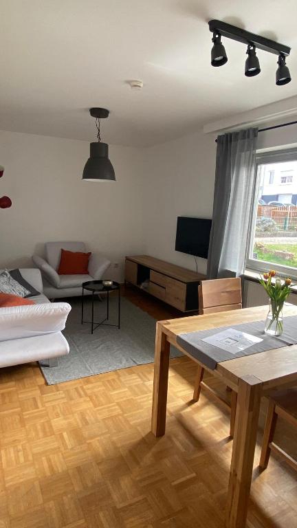 a living room with a table and a couch at Ferienwohnung Breininger in Lemberg