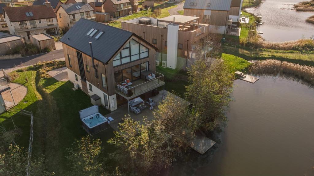 an aerial view of a house next to a river at Silvermere in Warmwell