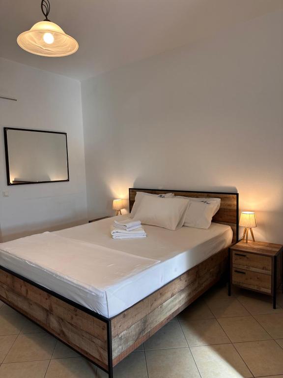 a bedroom with a large bed with two night stands at Elia I in Kondoliánika