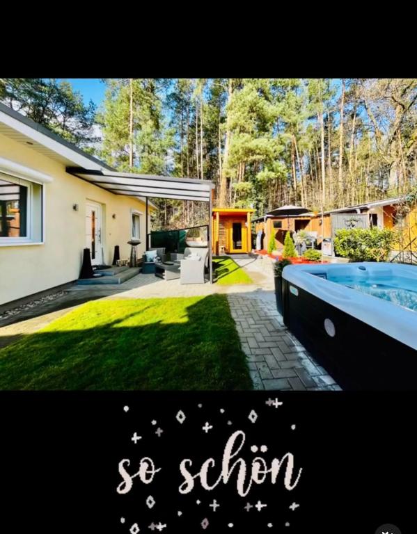 a house with a swimming pool in the yard at Wellness Ferienhaus Garden in Michendorf