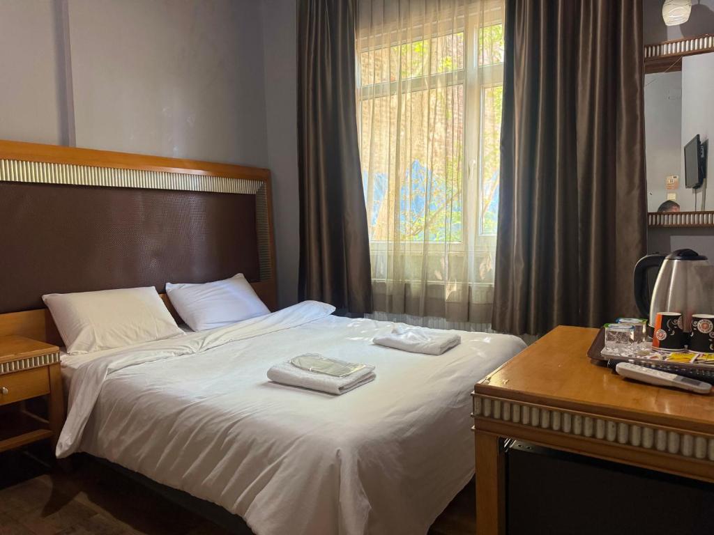 a bedroom with a bed with two towels on it at Herton Boutique Hotel in Istanbul