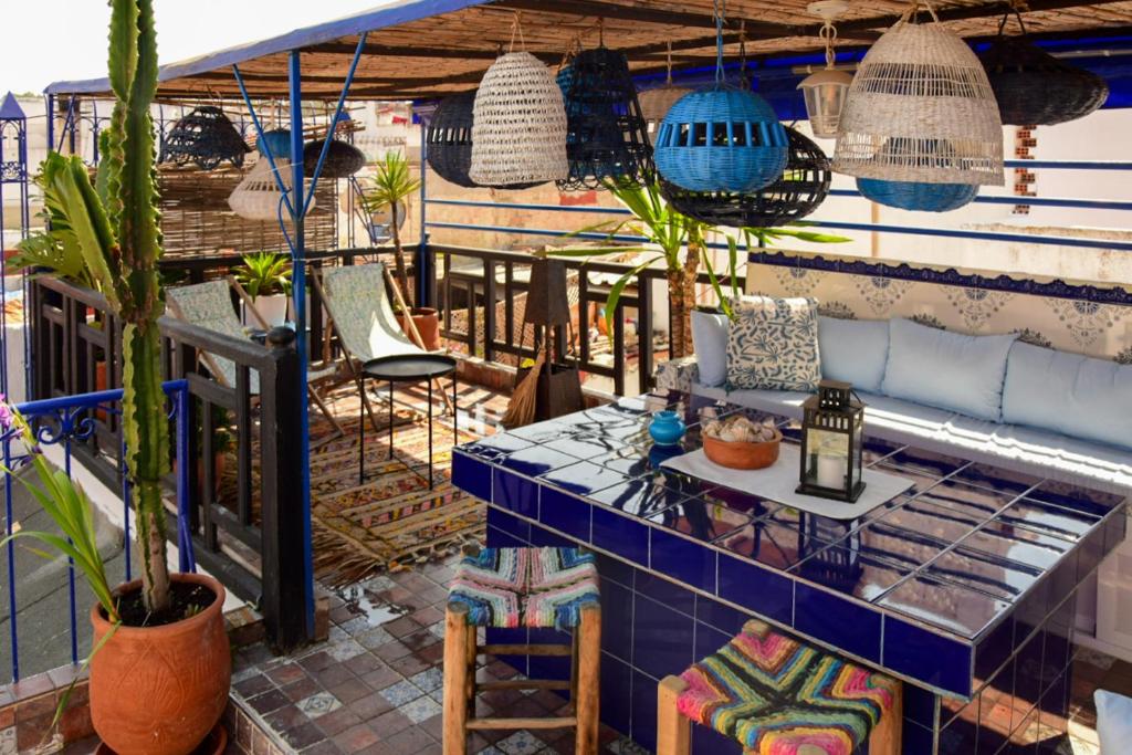a patio with blue tiles and potted plants at Dar Rania in Tangier