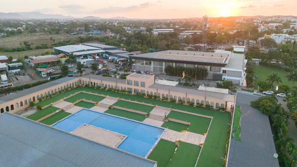 an aerial view of a house with a tennis court at The Democracy Hotel & Resorts Convention Center in Nashik