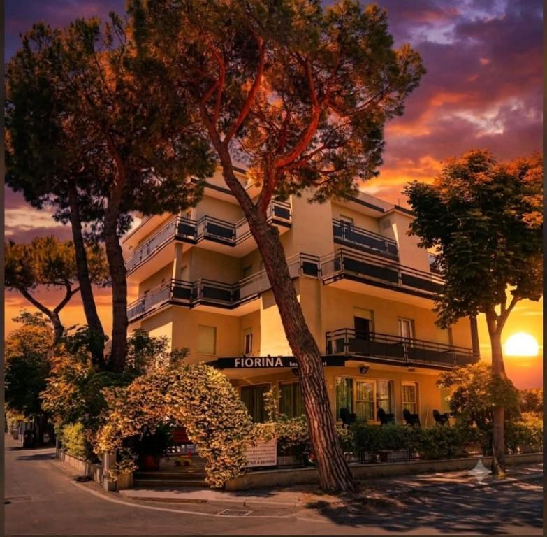 a building with a tree in front of it at Fiorina Bed&Breakfast - Colazione fino a mezzogiorno - Beach Village gratuito - Aquafan 25e - Oltremare 22e in Riccione