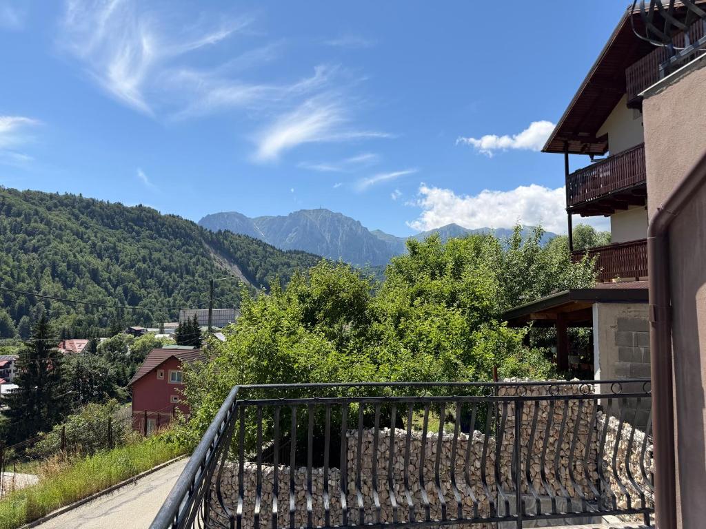 a balcony of a house with a view of mountains at Casa TimEva Azuga in Azuga
